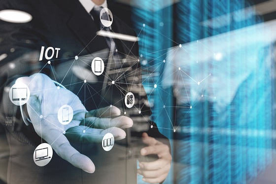 double exposure of hand showing Internet of things (IoT) word di